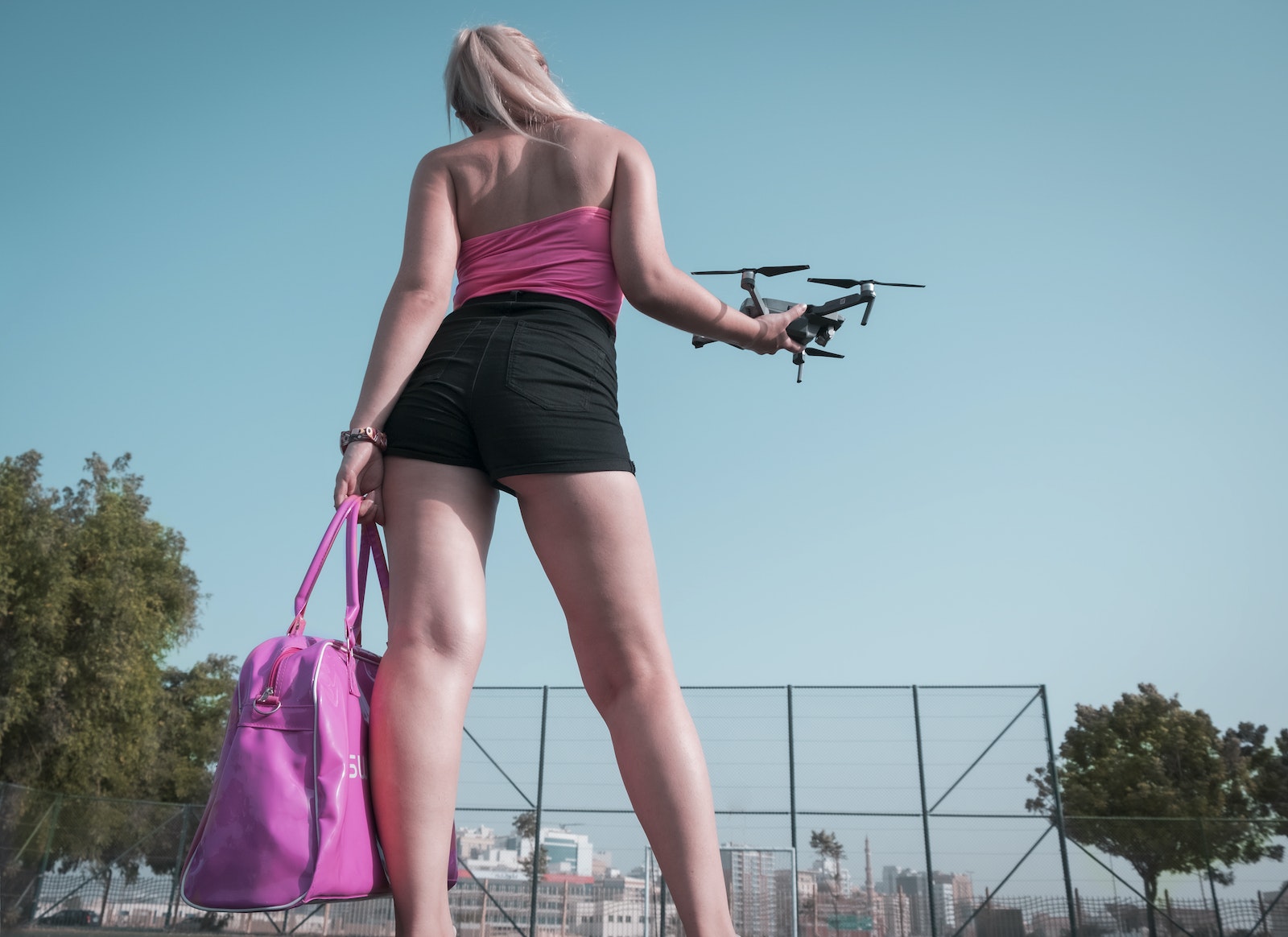 Woman Standing While Holding Quadcopter Drone