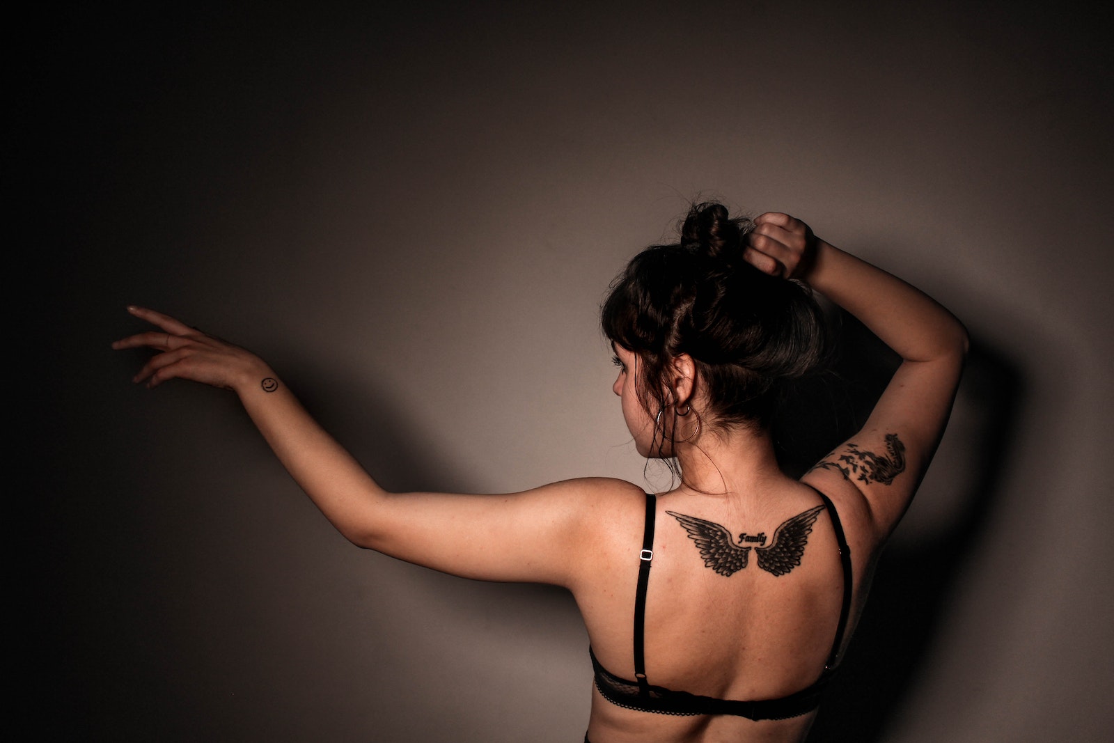 Woman in Eagle Tattoo in Back Wearing Black Bra